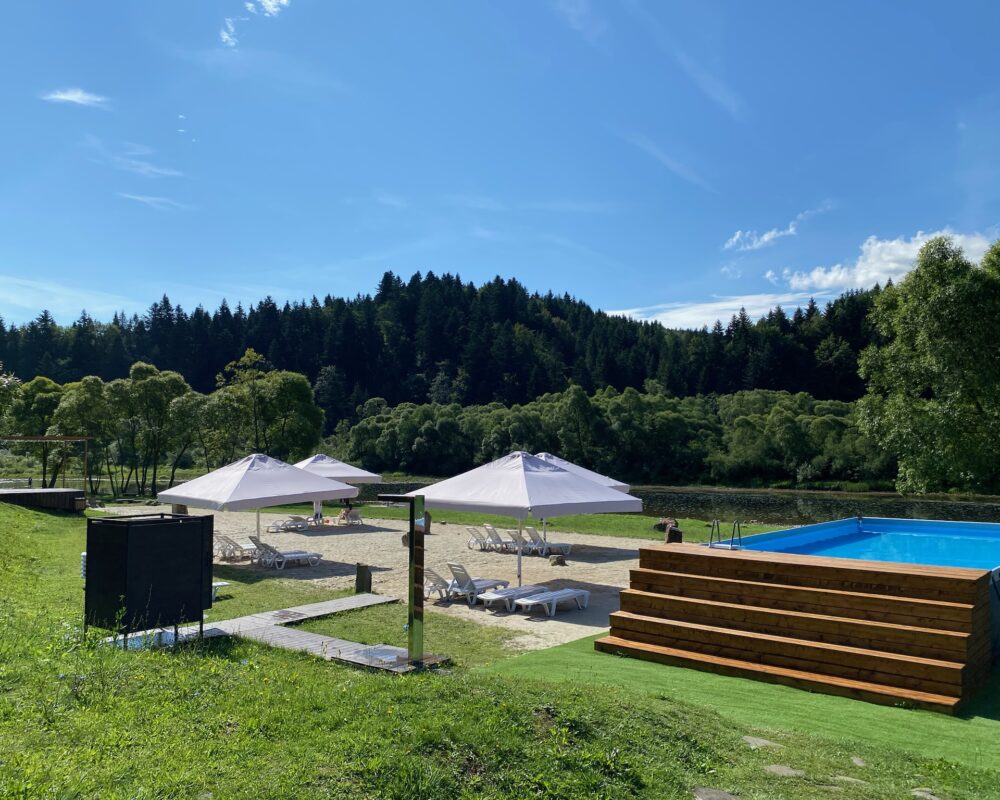 Summer vacation by the water. River beach and outdoor pool in Lviv region.